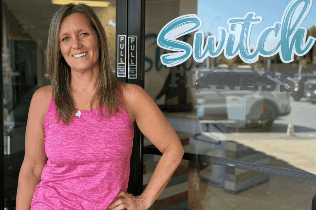 Woman standing in front of fitness studio.