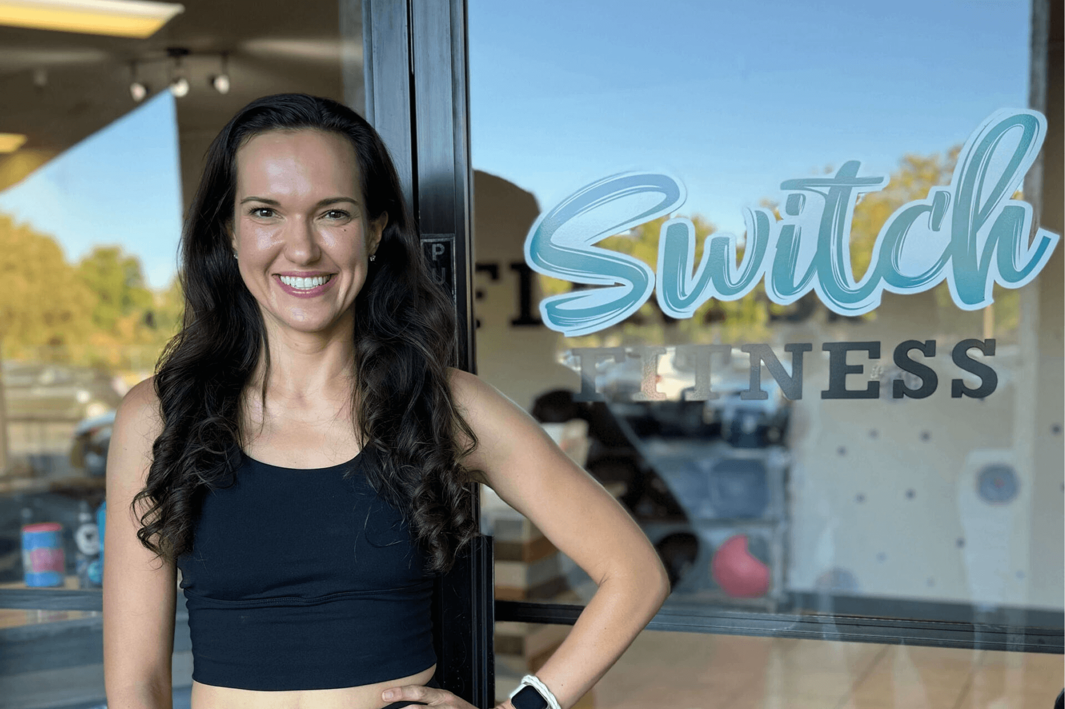 Woman smiling outside a fitness studio. Woman smiling outside a fitness studio.